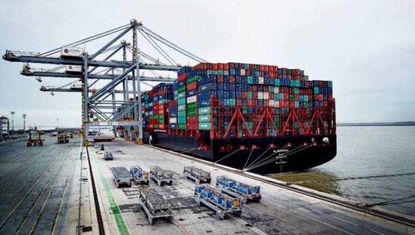 An image of a loaded cargo ship at a port.